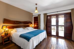 Postel nebo postele na pokoji v ubytování Vila Coqueiros Boutique Hotel