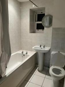 a bathroom with a tub and a toilet and a sink at Cwmynyscoy Cottage Pontypool NP4 5SQ in Pontypool