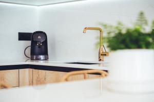 a kitchen with a sink and a coffee maker on a counter at Casa Boga in Puerto del Carmen +40 photos