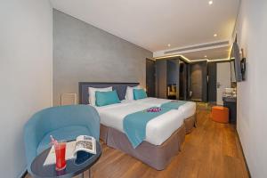 Łóżko lub łóżka w pokoju w obiekcie The Code Hotel & Spa Da Nang