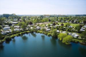 an aerial view of a river in a town at Glamping Betuwestrand in Beesd