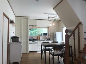 a kitchen with a table and a dining room at Villa Metasequoia - Vacation STAY 71245v in Takashima