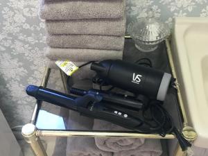 a black flashlight on a rack next to towels at Villa Metasequoia - Vacation STAY 71245v in Takashima