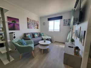 a living room with a couch and a table at Skyline 21 in Torrevieja