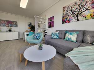 a living room with a couch and a table at Skyline 21 in Torrevieja