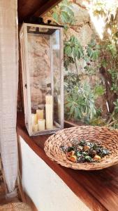 a wicker basket with candles and a bowl of food at chambre love romantique avec spa privée in Calvi