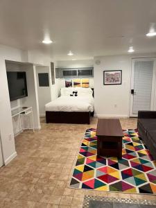 a bedroom with a bed and a couch and a tv at Stay in the heart of Logan Circle: Fully Walkable in Washington