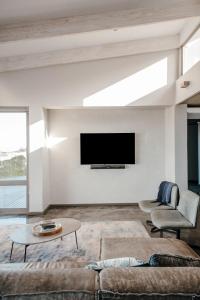 a living room with a couch and a tv at At Last Glentana Beach Manor in Glentana