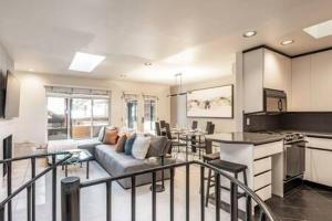 a large living room with a couch and a kitchen at 2 BR 3BA Condo - AC, Heated Pool, Walk to Town in Aspen