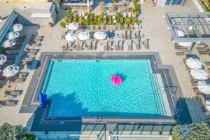 an overhead view of a swimming pool with a pink ball at Condo Bay View Infinity Pool Beach Service in Hollywood +67 photos