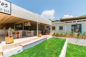 an outdoor patio with a table and chairs at N. Ammos Lichnos in Parga