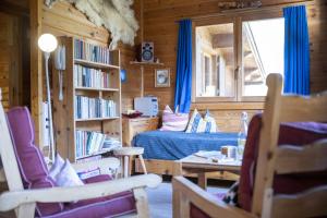 a bedroom with a bed in a wooden cabin at Chasa Avant Porta in Ramosch