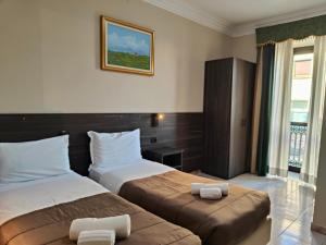 Postel nebo postele na pokoji v ubytování Hotel Romano