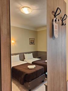 Postel nebo postele na pokoji v ubytování Hotel Romano