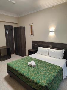 Postel nebo postele na pokoji v ubytování Hotel Romano