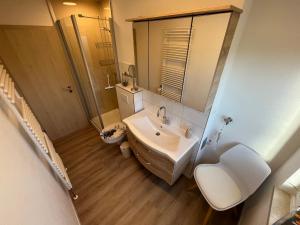 a bathroom with a tub and a sink and a toilet at Harzliebhaber 2 in Altenau +17 photos
