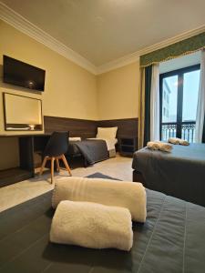 Postel nebo postele na pokoji v ubytování Hotel Romano