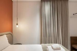 a hotel room with a bed and a window at BHomy Consolacao - Estiloso de 2 quartos MR132 in Sao Paulo