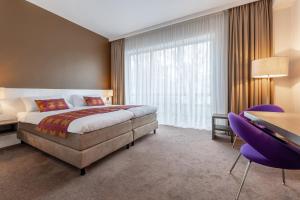 Postel nebo postele na pokoji v ubytování Hotel Lumen Zwolle