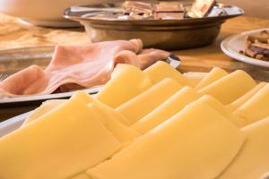a bunch of cheese and ham on a table at Hotel B&B Gladys in Cesenatico
