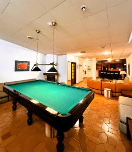 a pool table in the middle of a living room at LagosMar Story Hotel in Lagos