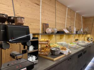 a kitchen with a counter with food on it at Al Piccolo Hotel in Vigo di Fassa +81 photos