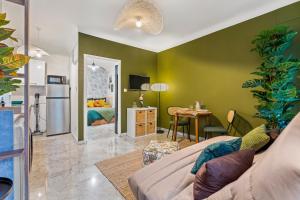 a living room with green walls and a dining room at Nice Renting - FODERE - Charm & Comfort 2P Heart of Nice - AC & WiFi in Nice