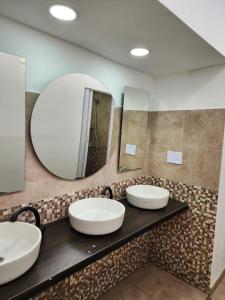 two sinks in a bathroom with a large mirror at Salta eco alojamiento in Salta