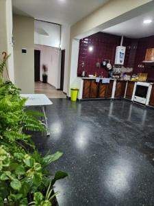a large empty room with a kitchen and a counter at Salta eco alojamiento in Salta