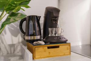 a black blender sitting on top of a wooden stand at Nice Renting - FODERE - Charm & Comfort 2P Heart of Nice - AC & WiFi in Nice