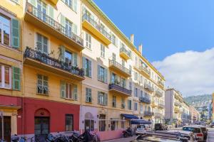 a row of buildings on a street with bikes parked outside at Nice Renting - FODERE - Charm & Comfort 2P Heart of Nice - AC & WiFi in Nice