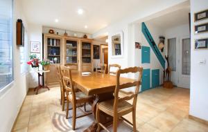 a dining room with a wooden table and chairs at Holiday Home Agon Coutainville in Agon Coutainville
