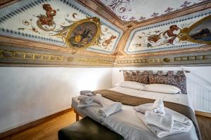 1 dormitorio con techo con pinturas en las paredes en Roommo Pergola, en Florencia