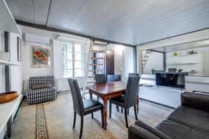 a living room with a wooden table and chairs at Roommo Pergola in Florence