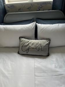 a pillow sitting on top of a bed with white pillows at Most Easterly Guest House in Pakefield