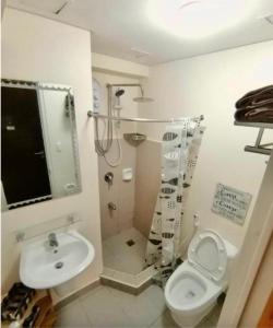 a bathroom with a toilet and a sink at JmR Serin West studio unit pay by Gcash or cash only in Tagaytay