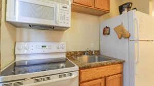 a small kitchen with a sink and a microwave at Oak Shores Studio 39 in Biloxi