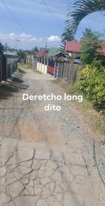 a dirt road with the words detroit long club at Leigh HomeStay in Alaminos