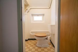 a small bathroom with a toilet and a window at Chasa Muglinér 115 in Scuol +20 photos