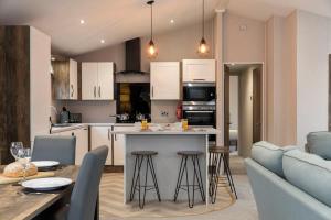 a kitchen and living room with a table and chairs at Ribble Valley Country and Leisure Park 