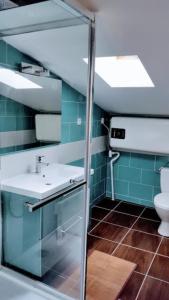 a bathroom with a sink and a toilet at Les Roses de Jonzac in Mortiers