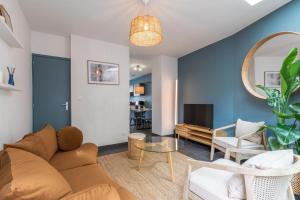 a living room with a couch and a table at 3 bedroom house with terrace near Lille in La Madeleine