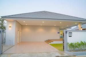 a home with a garage with a driveway at Temmy Pool Villa, Chaam - Hua Hin in Phetchaburi