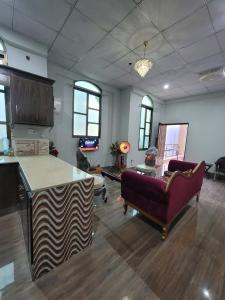 a living room with two couches and a couch in a room at Patriata Luxury Suits in Murree