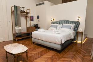 a bedroom with a large bed and a table at Villa Clio, a Luxury Collection in Thessaloniki