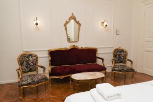 a room with two chairs and a couch and a mirror at Villa Clio, a Luxury Collection in Thessaloniki