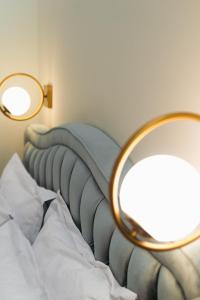 a bedroom with a bed with a mirror on it at Villa Clio, a Luxury Collection in Thessaloniki