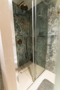 a shower in a bathroom with a glass shower stall at Villa Clio, a Luxury Collection in Thessaloniki