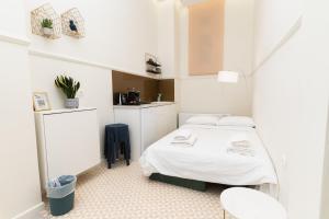 a white room with a bed and a kitchen at Villa Clio, a Luxury Collection in Thessaloniki
