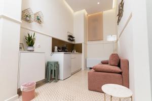 a living room with a chair and a table at Villa Clio, a Luxury Collection in Thessaloniki
